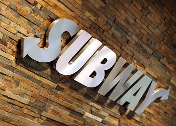 a picture of the subway logo on a brick wall