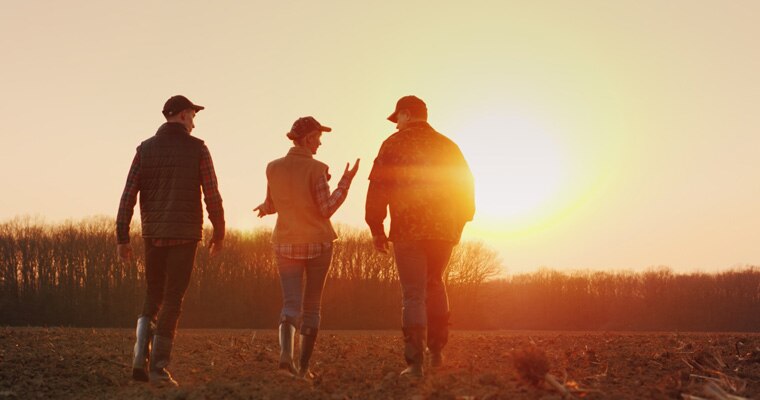 Three people on a farm