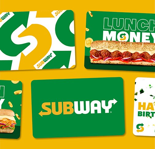 Subway® gift cards lying flat on a yellow surface.