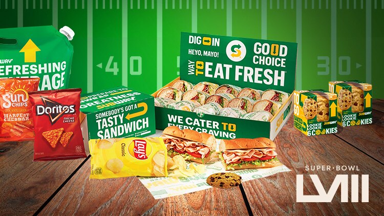 Chips, cookies and catering box on table with Super Bowl logo