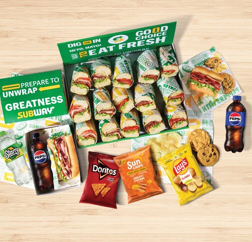 Subway® Catering subs, chips, cookies and Pepsi products on countertop.