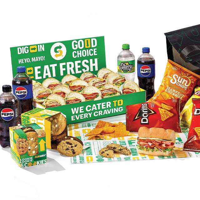 Subway® Catering subs, chips, cookies and Pepsi products on countertop.
